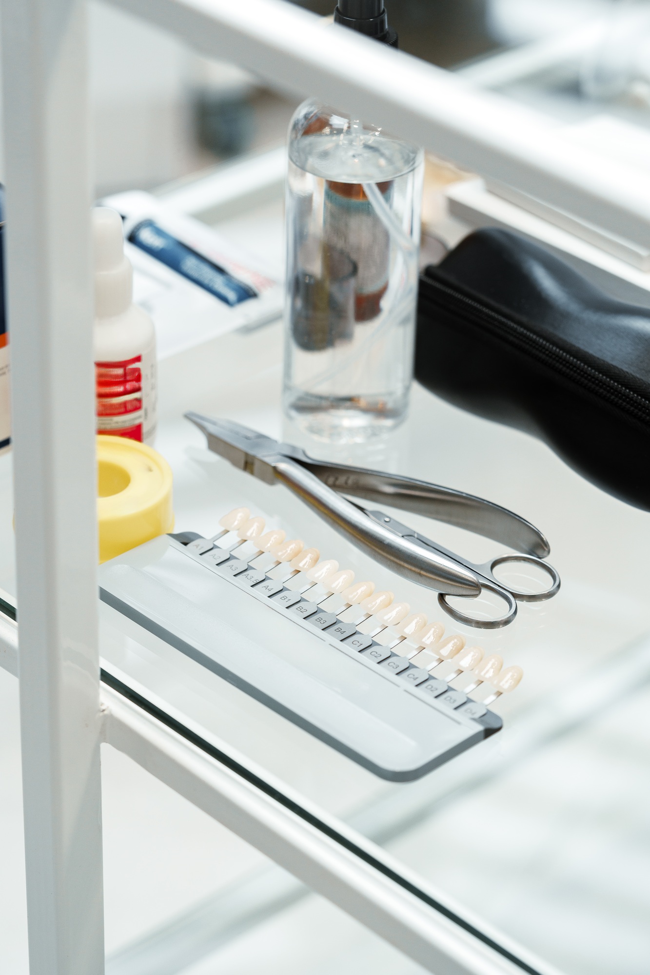 dental lab setup showcasing various shades of artificial teeth alongside dental tools