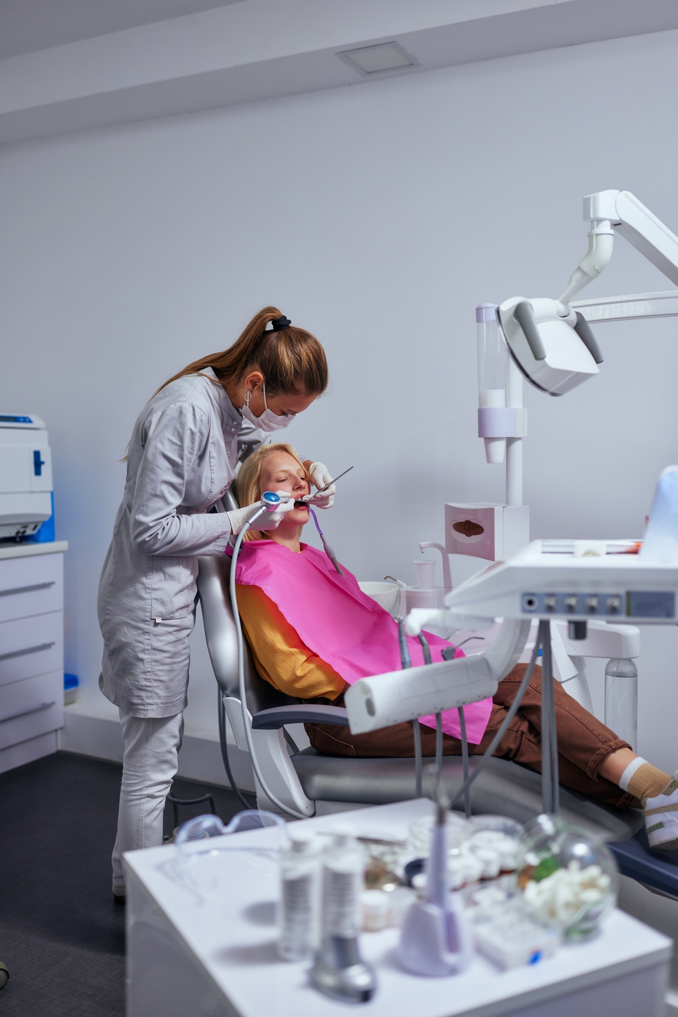 Dentist examining the teeth of a young woman