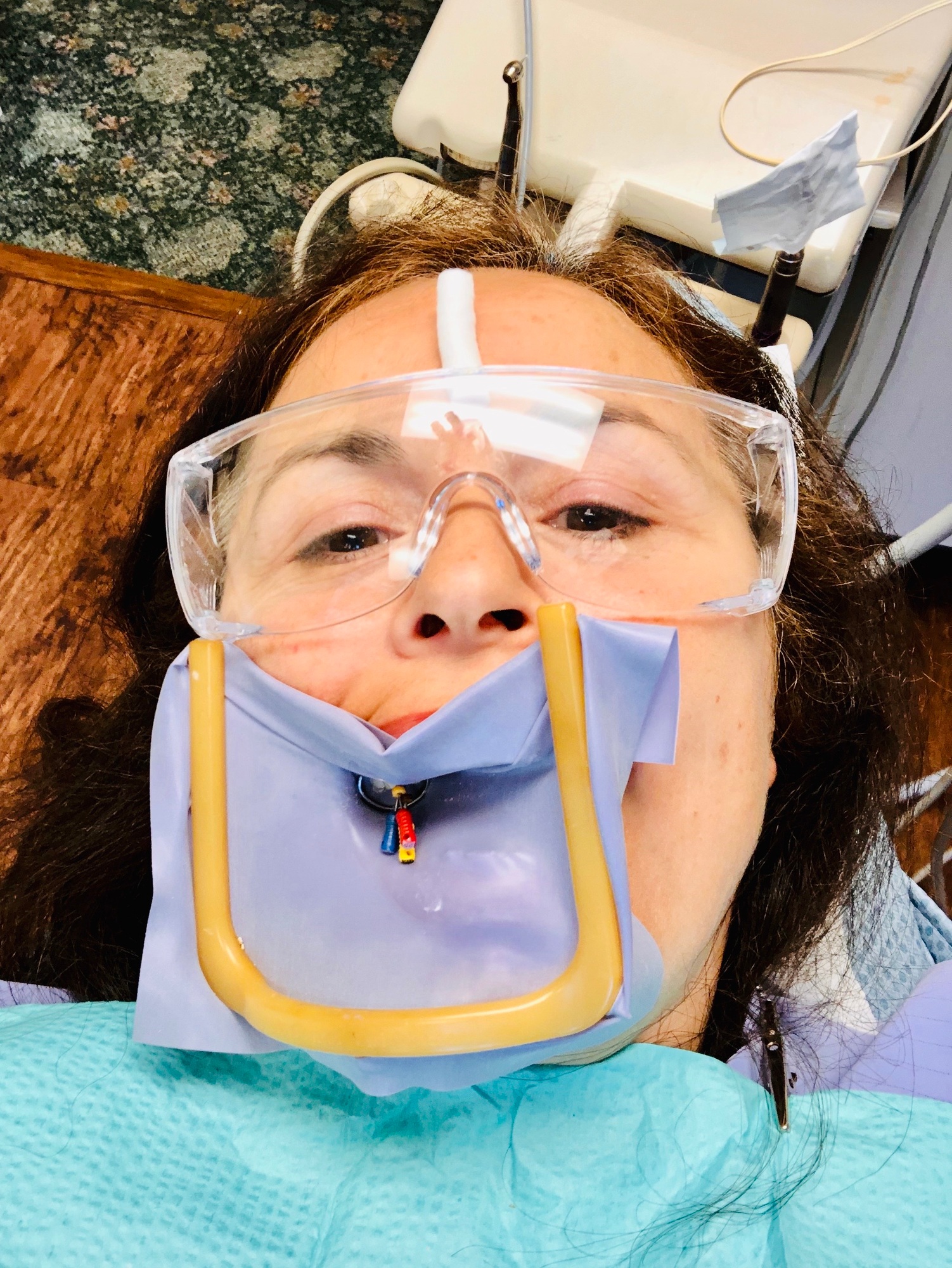 Woman at the dentist getting a root canal done.